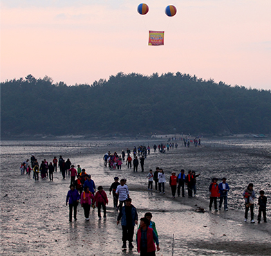 사람들이 갯벌에서 놀고 있는 모습