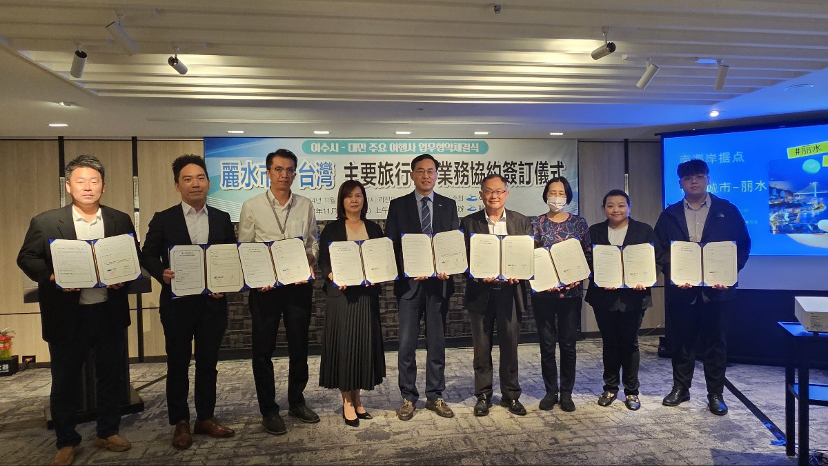 여수시와 대만 주요 도시 간의 협약 체결식에서 참석자들이 서류를 들고 포즈를 취하고 있다.