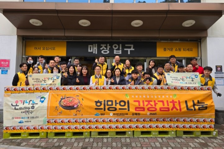 매장 입구 앞에서 김장김치 나눔 행사를 위해 모인 자원봉사자들이 기념사진을 찍고 있다.