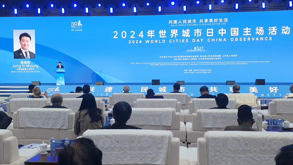 2024 세계 도시의 날 중국 기념 행사가 진행되고 있으며, 연단에서 정기명 여수 시장이 발언하고 있다. 참석자들이 연단을 바라보며 경청하고 있다.